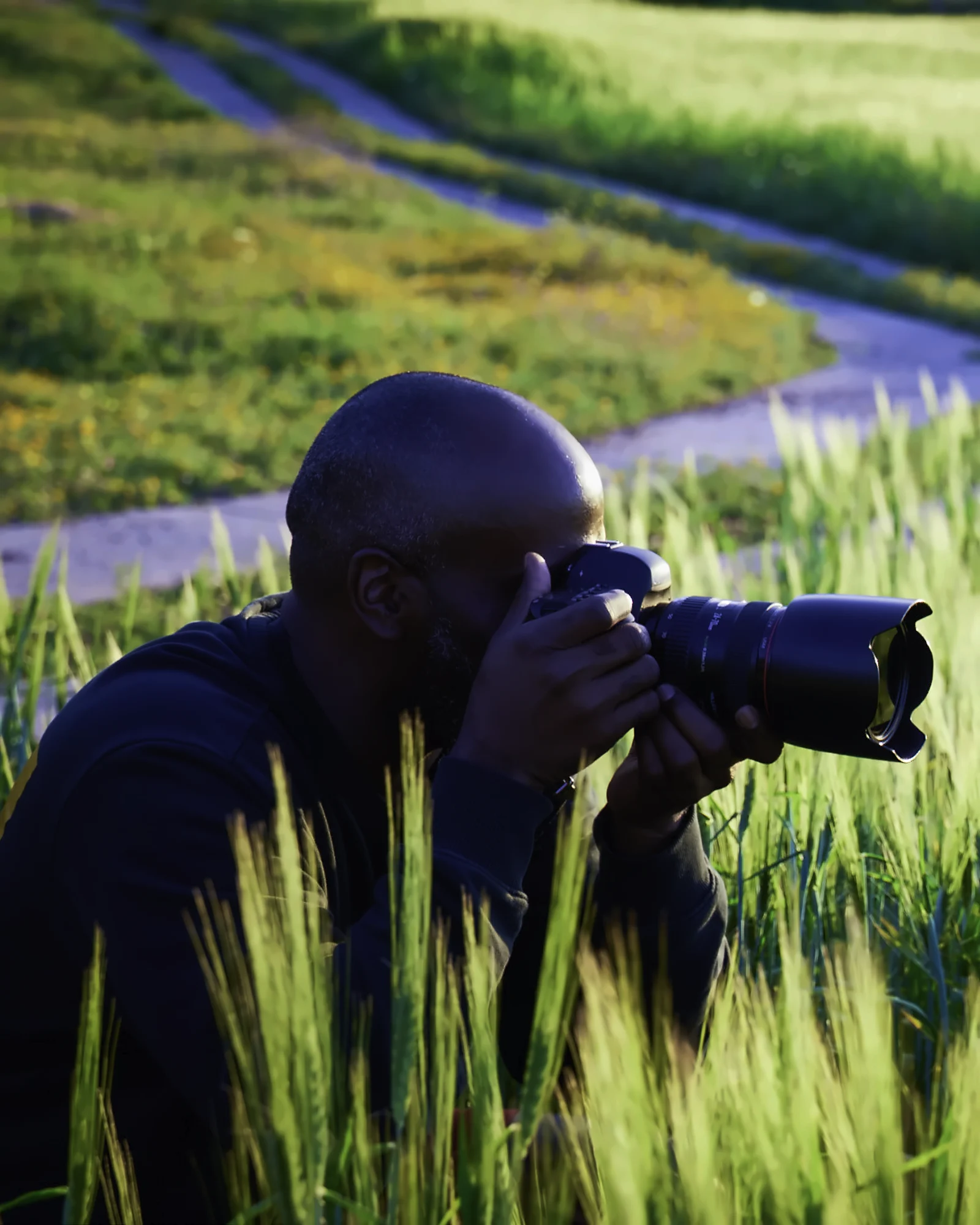 Willie Mack photographing in a wheat field